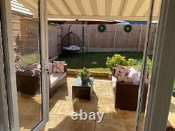 Rattan garden furniture, 2 two seater settees, a rattan glass topped table